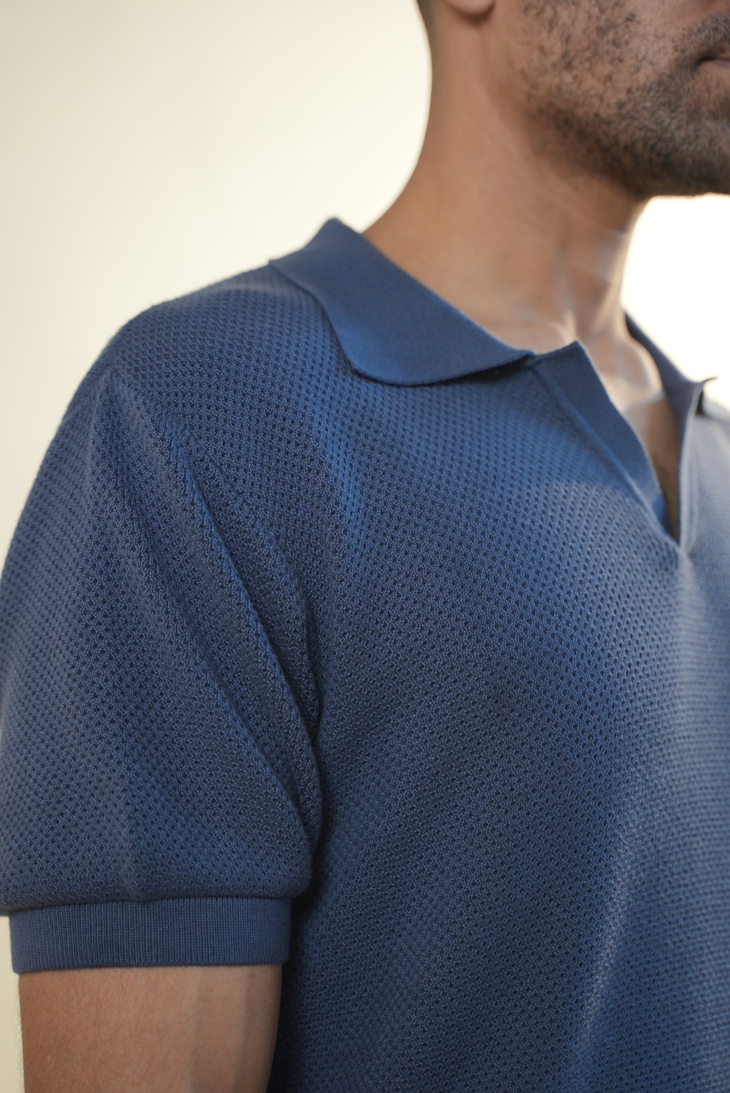 Men wearing Soft denim polo with side angle
